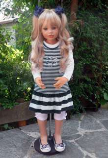   Worldwide Hair: Blonde Eyes: Dark Blue Wooden Doll Stand Included